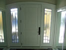 Arched Mastergrain Fiberglass 2 Panel with Custom Wrough Iron Sidelites